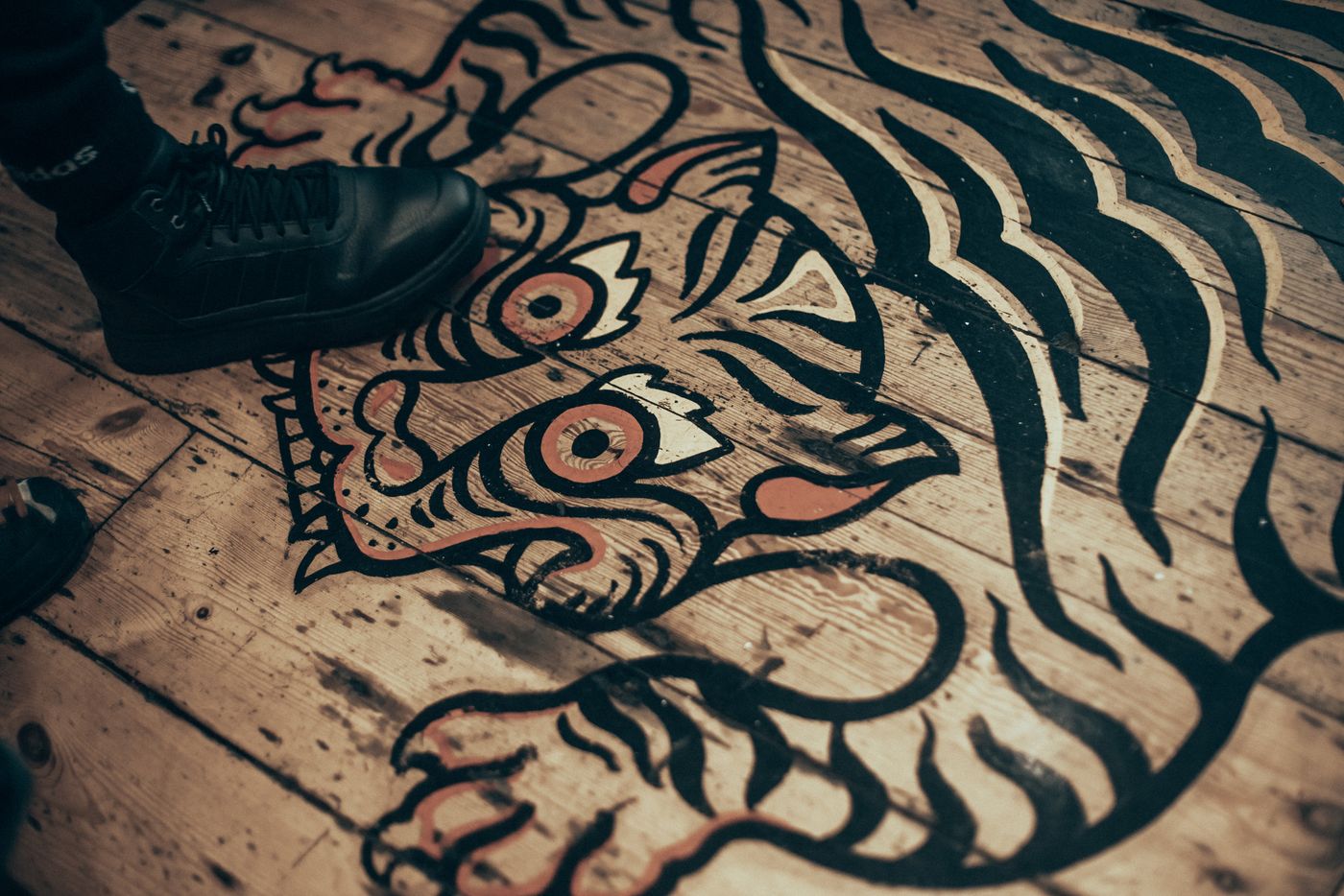 A tiger on the floorboards.