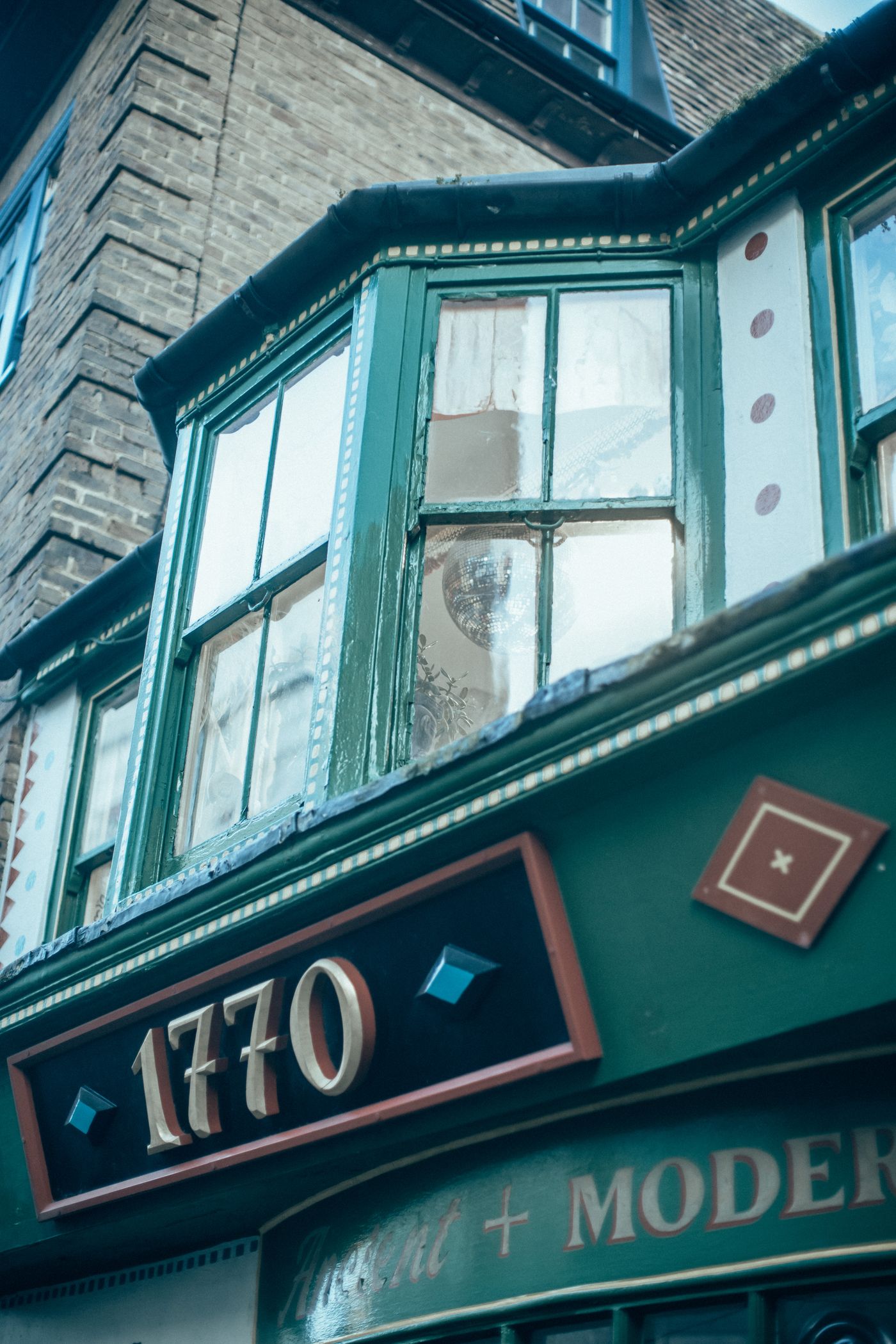 An old shopfront, painted green.