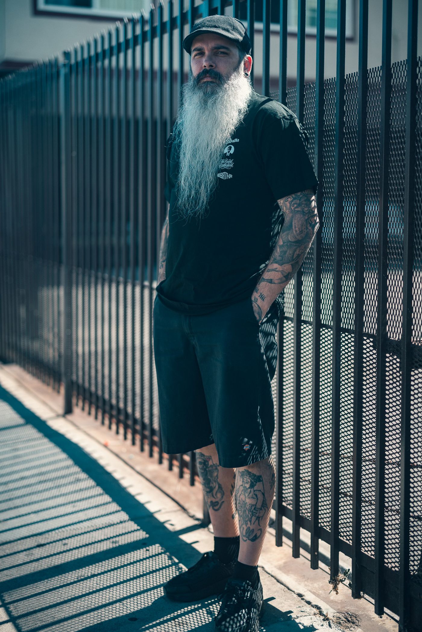 Black tee, iron fence.